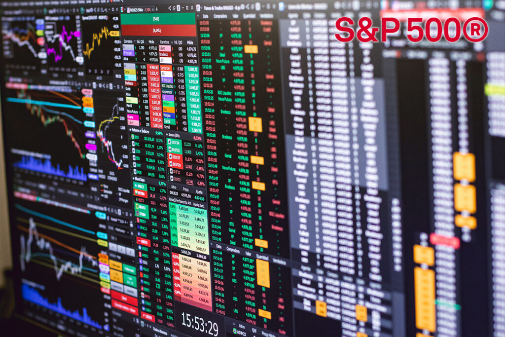 Multiple monitor displays showing stock charts, data tables, and a red S&P 500® logo in the top-right corner.